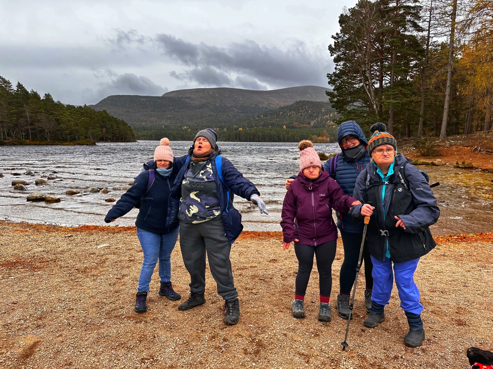 Residents and staff on a walk by a loch in the Scottish Highlands