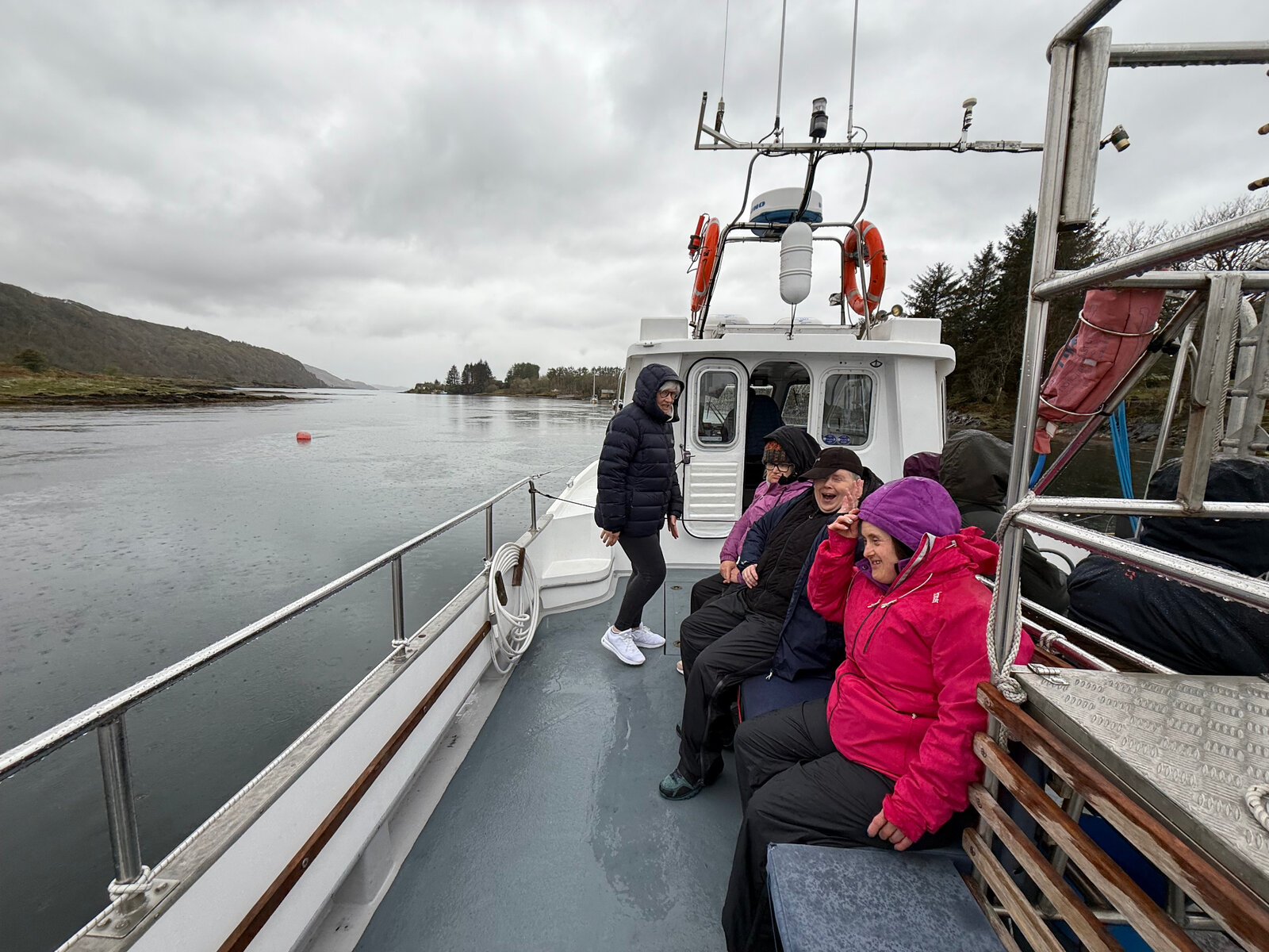 Residents on a boat trip along a Scottish loch