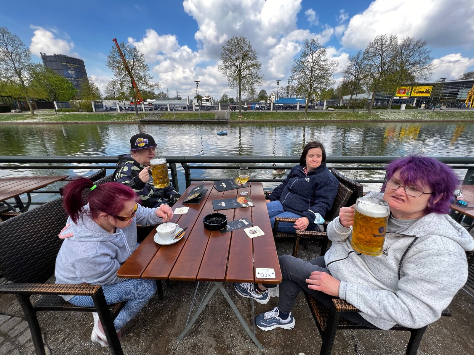 Residents enjoying drinks together by the waterfront