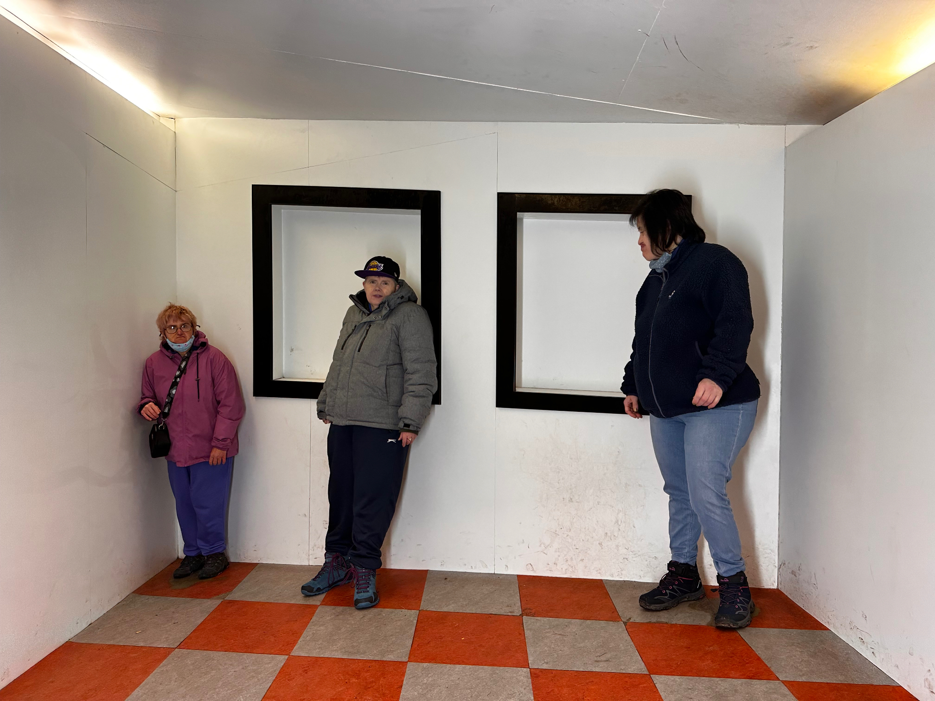 Residents visiting an optical illusion room attraction