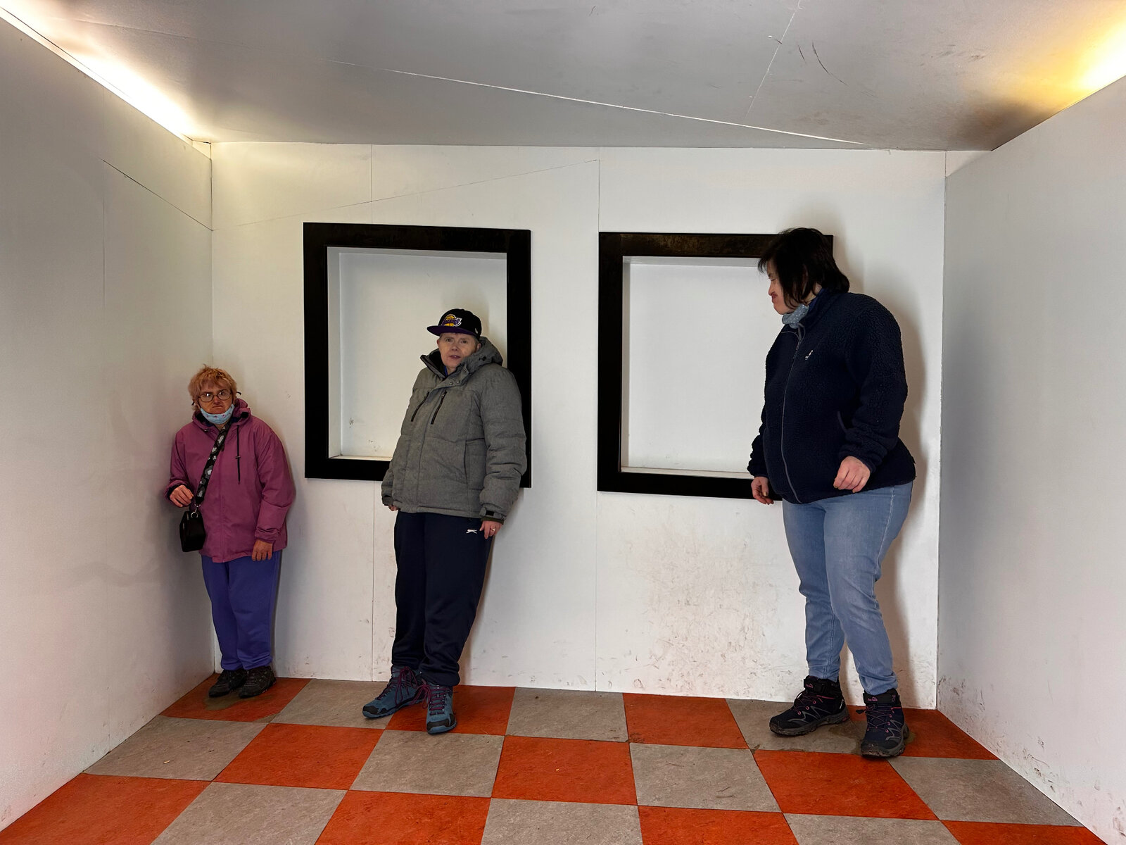 Residents visiting an optical illusion room attraction