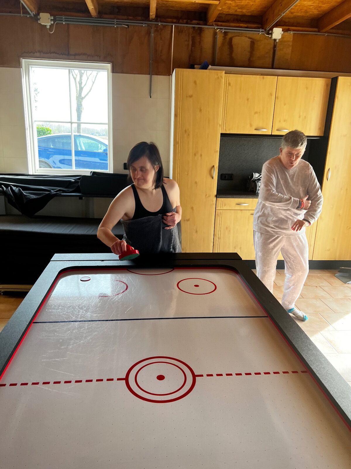 Residents playing air hockey together