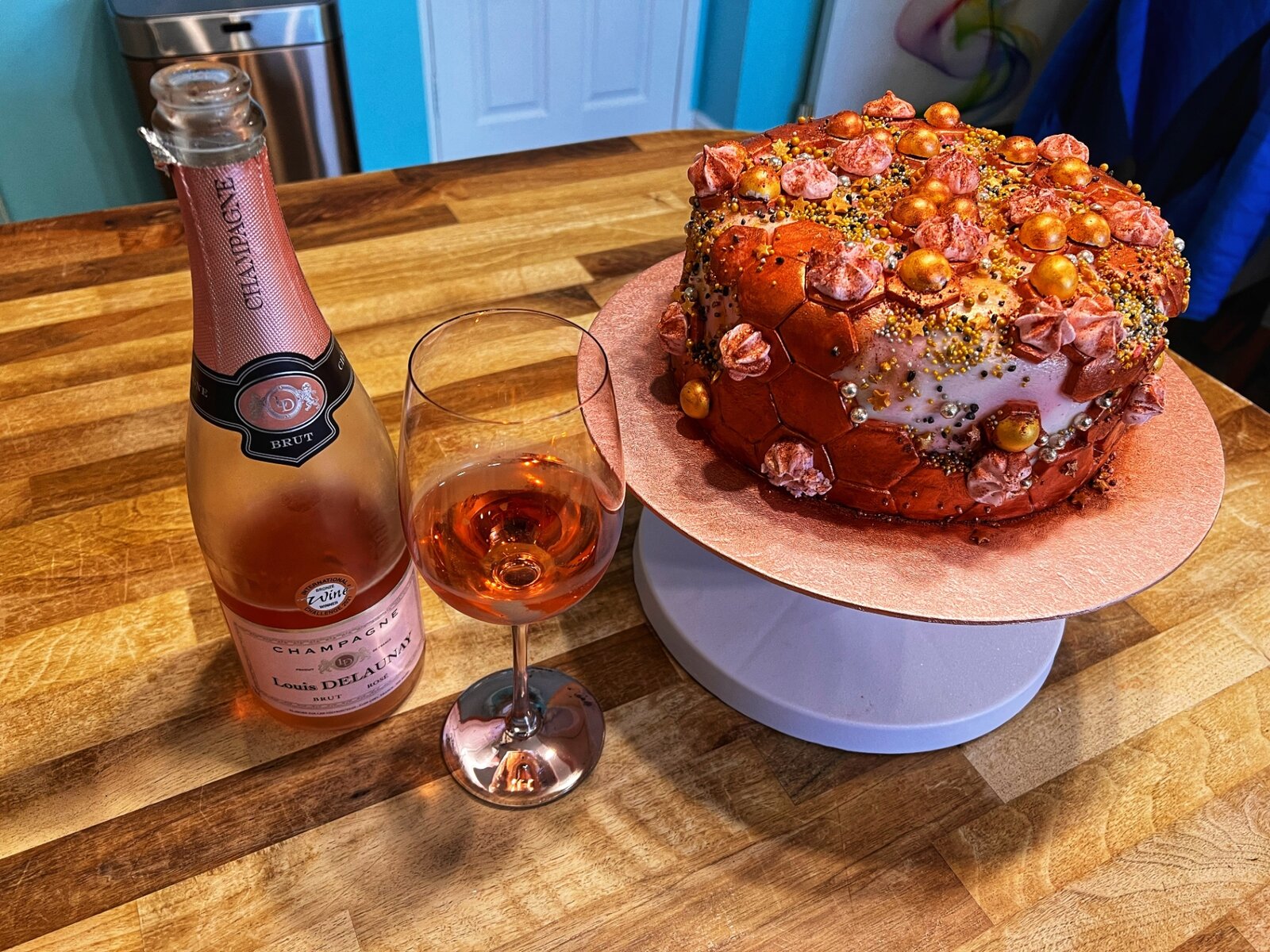 Rose gold celebration cake with champagne