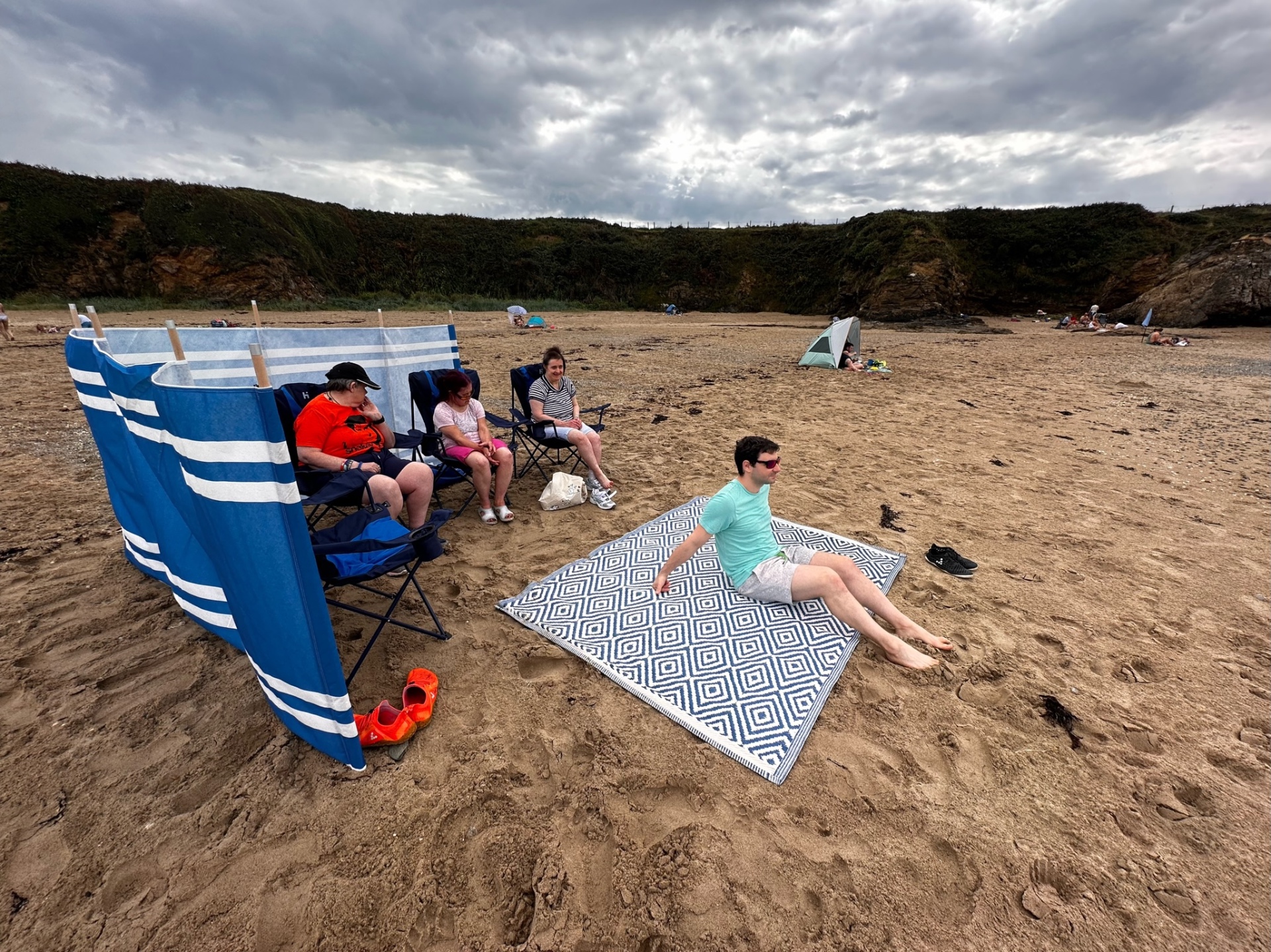 Residents relaxing on a sandy Anglesey beach
