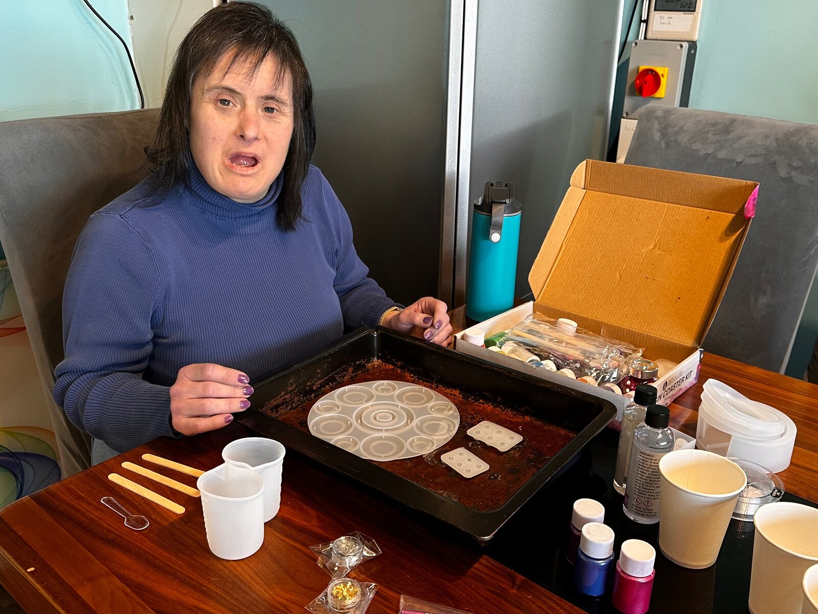 A resident taking part in a craft activity with a resin coaster kit