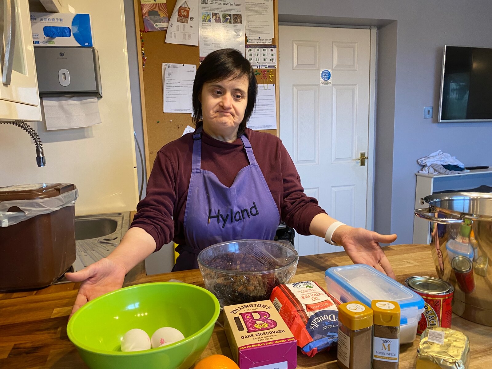 A resident in a Hyland apron preparing ingredients for baking