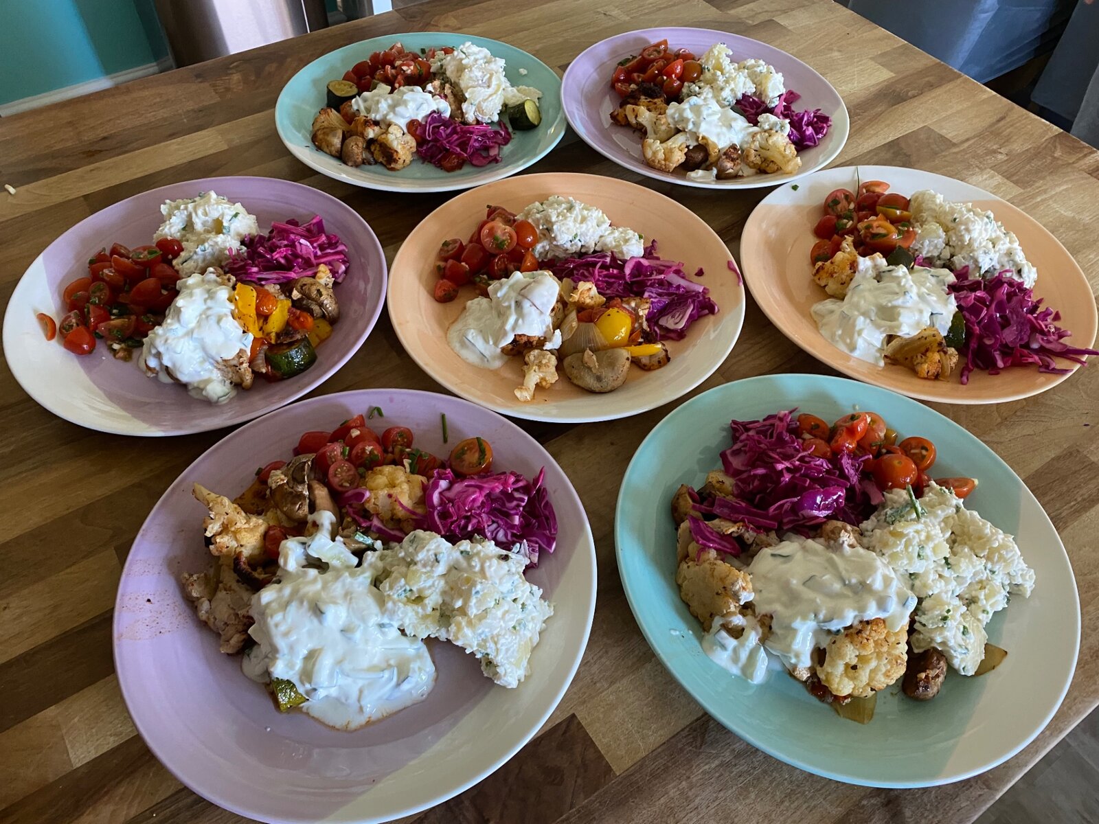 A colourful finished meal with roasted vegetables and salads