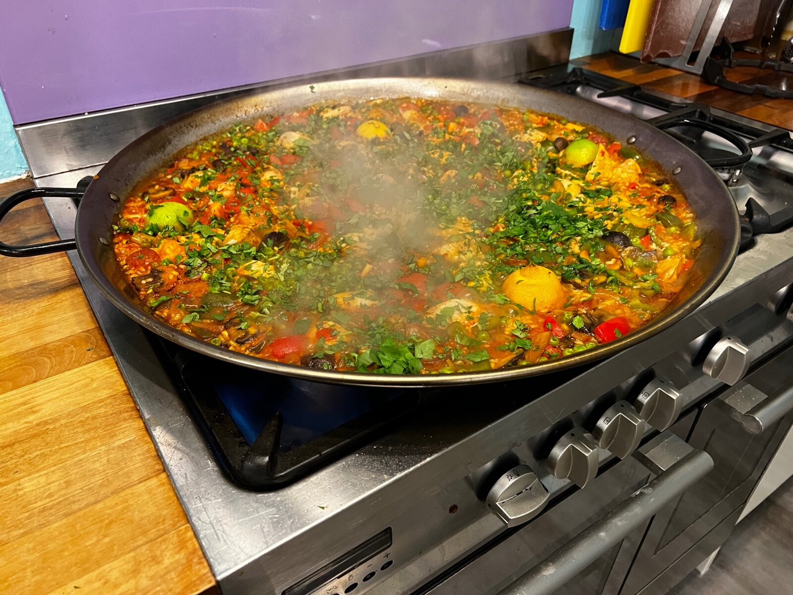 A large pan of freshly cooked paella on the hob