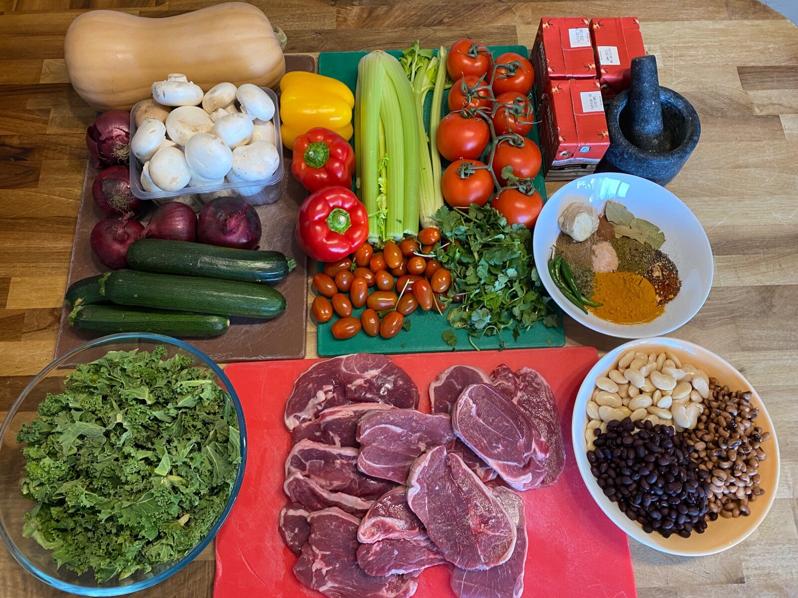 Fresh meat, greens, beans and vegetables ready to be cooked