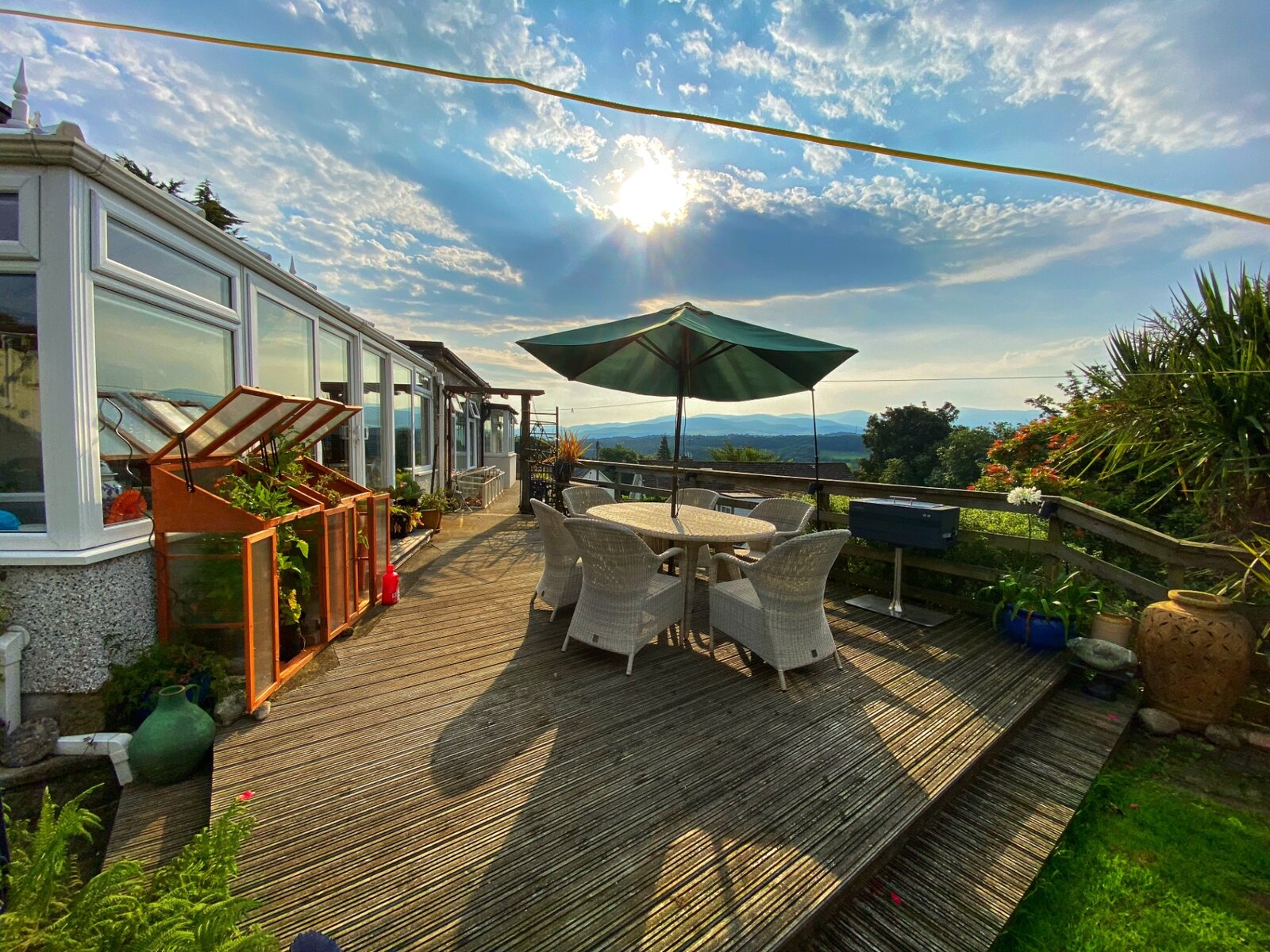 The garden decking at Hyland Residential Home with outdoor seating and views of the surrounding countryside